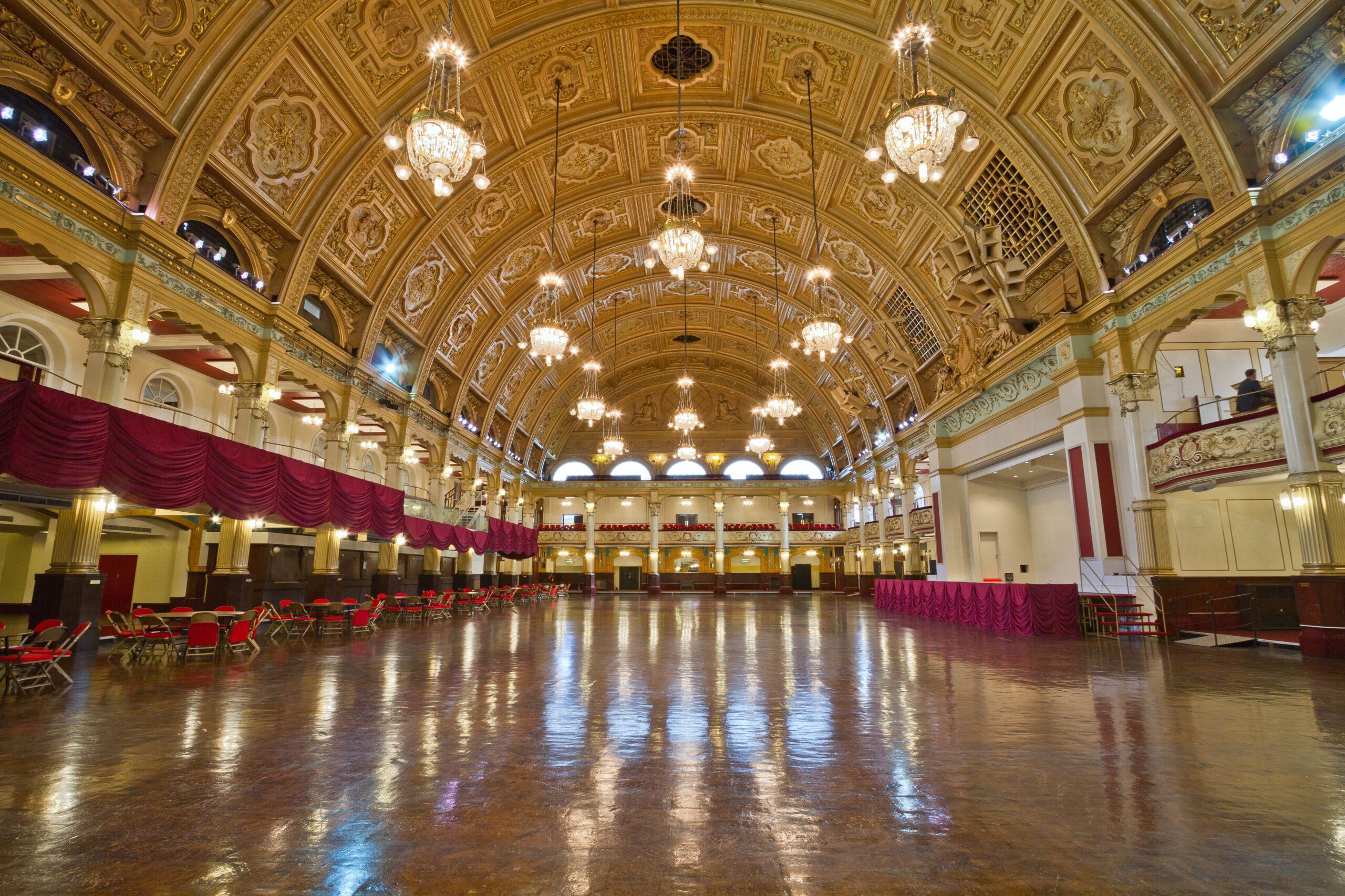 An elegant ballroom illuminated by crystal chandeliers, capturing the timeless sophistication of cascading luxury strings.