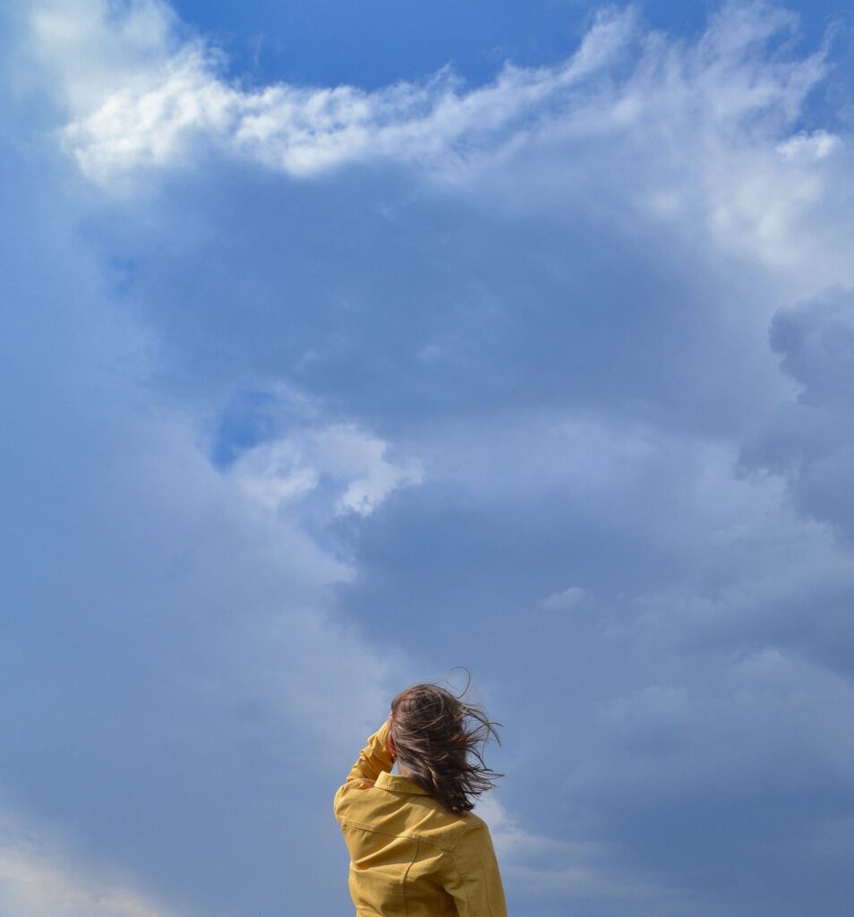 Person quietly observing the sky and clouds