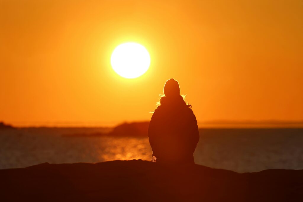 Person quietly watching the sunset
