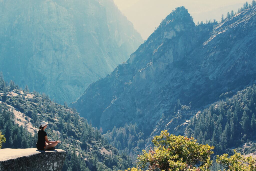 Person practicing mindfulness meditation outdoors