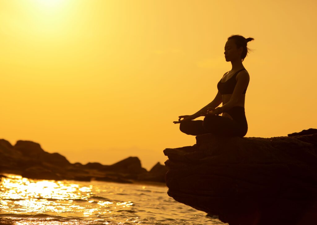 Person contemplating the horizon at sunset