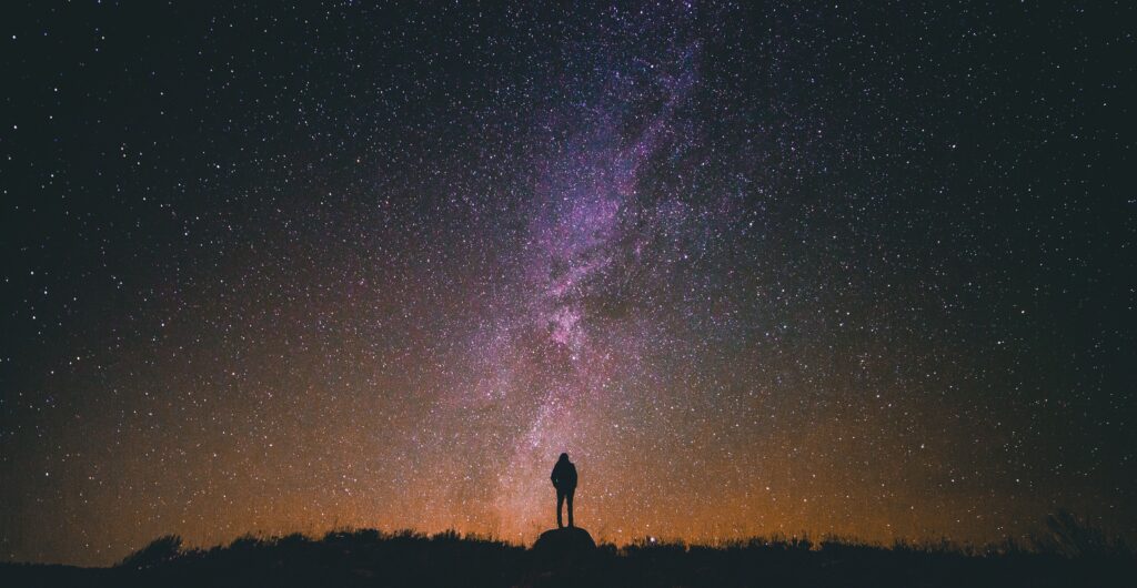 Person gazing at the night sky in contemplation