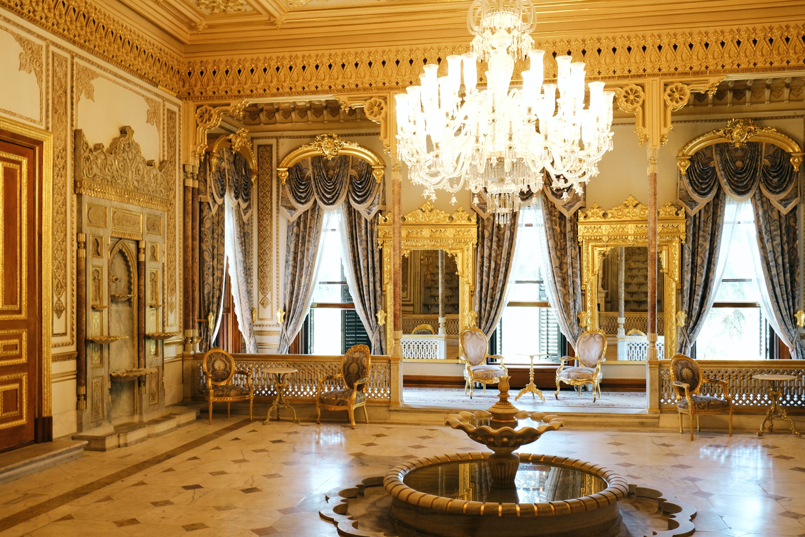 An elegant royal salon adorned with crystal chandeliers, gilded mirrors, and timeless evening refinement.
