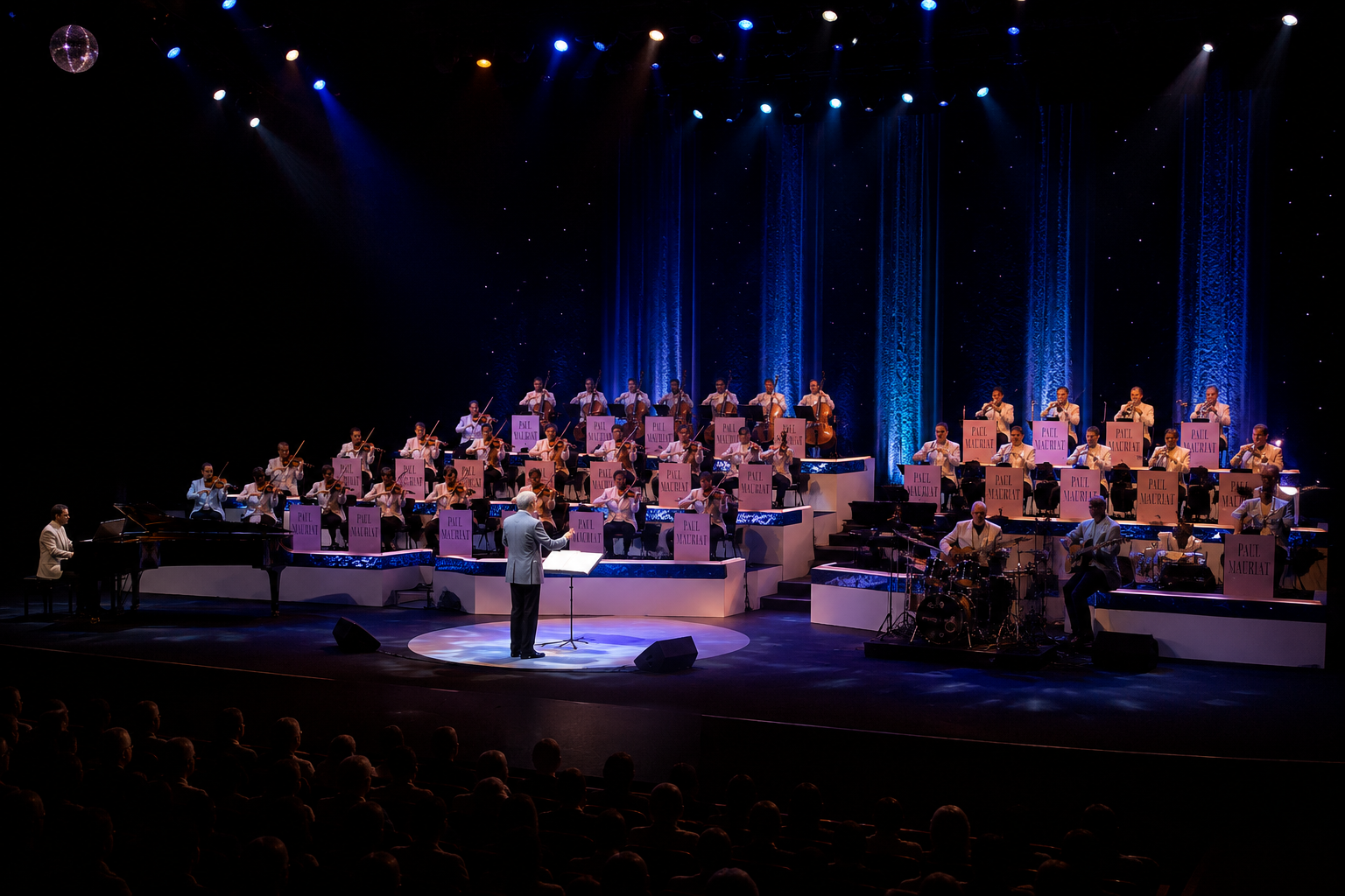 Paul Mauriat conducting his world touring orchestra on a spacious concert stage with strings, brass, piano, percussion, elegant blue lighting, and an international live audience.