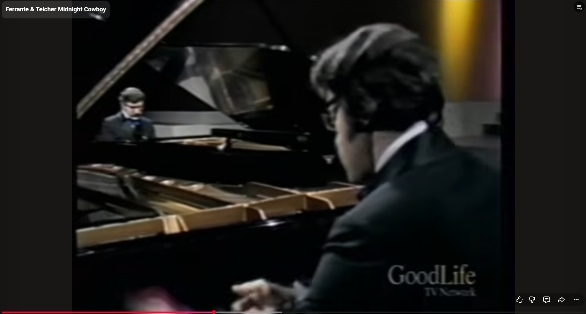 Ferrante & Teicher performing at two grand pianos with a full orchestra during an elegant concert featuring their signature twin-piano arrangements.