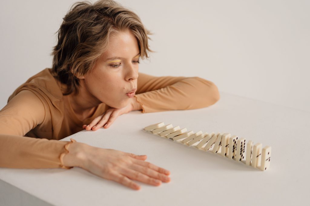 Falling dominoes illustrating a sequence of causes and conditions